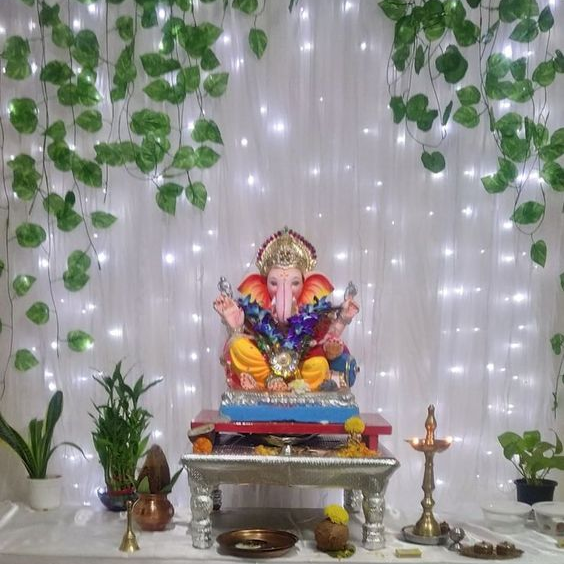 Ganpati decoration done with fresh flowers, tradional lamps and led lights  | Fresh flowers, Led lights, Decor